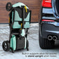 Pride Mobility Go-Go Super Portable Scooter folded upright next to a car, showcasing its convenient design.