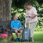 Eclipse 5 oxygen concentrator rental being used outdoors by a woman and a child, highlighting transportability and ease of use.