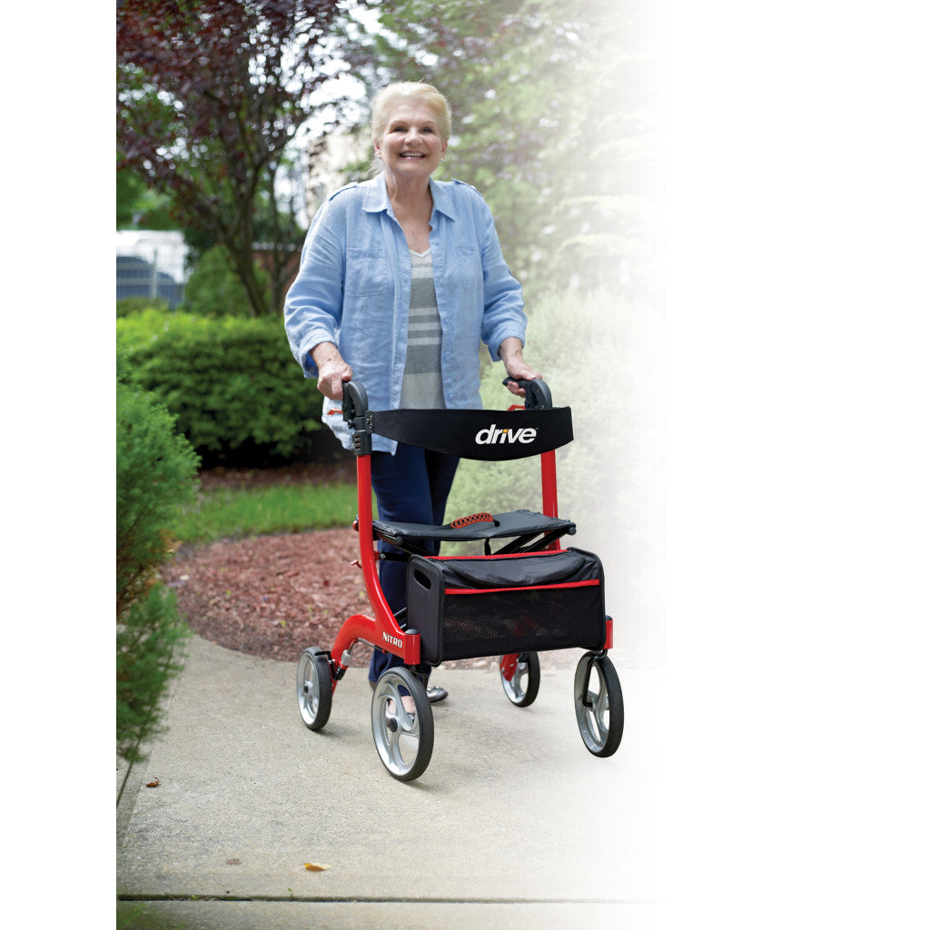 Drive Medical RTL10266 Nitro Euro-Style 4-Wheel Rollator being used by a smiling woman outdoors in a scenic environment.