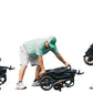 Person demonstrating how to fold the Jazzy Carbon Heavy Duty Travel Power Wheelchair Rental for easy transport in a vehicle.
